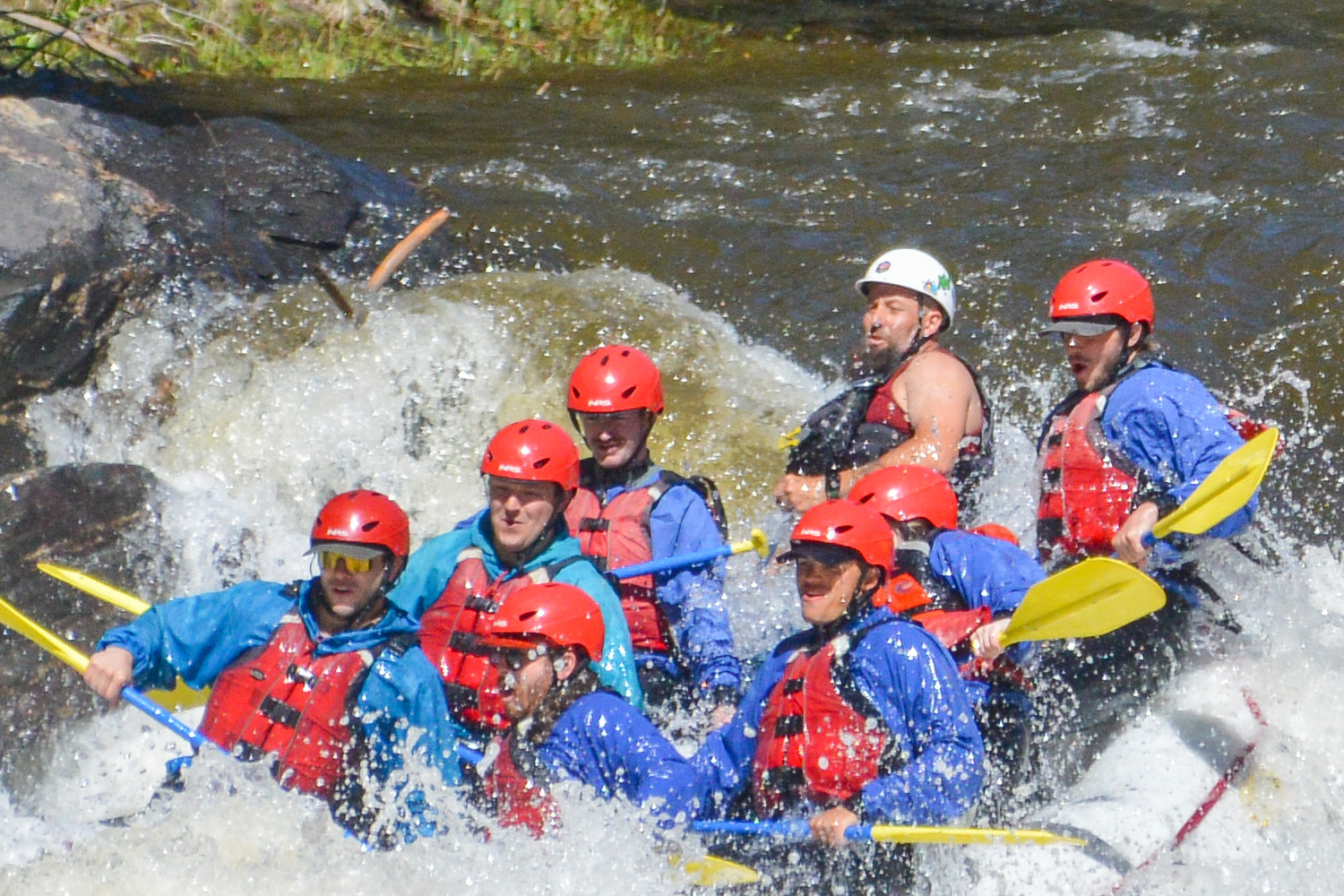 Close up of guests getting splashed rafting through Clear creek - Idaho Springs, Colorado