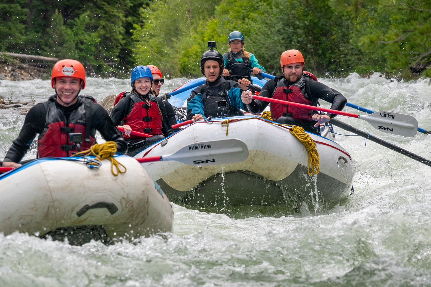 Two rafts with smiling people in the boat rafting through the Upper Animas River - Needleton, Colorado - Mild to Wild