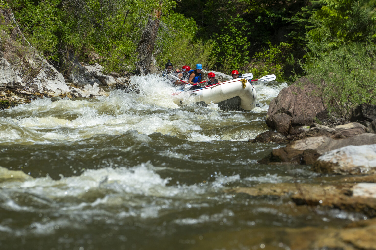 Raft splashing down the Piedra River Canyon near Pagosa Springs