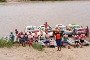 Group of rafters listening to a guide safety talk on a Multiday Moab Rafting trip