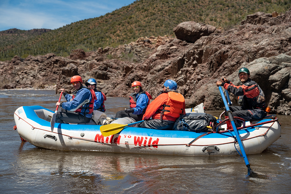 Medium shot of raft on the Salt River with desert landscape surrounding - Mild to Wild