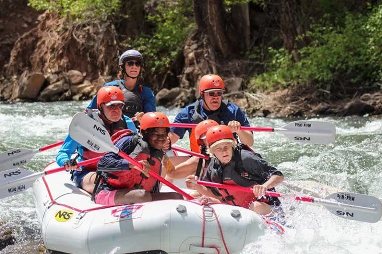 close up of guests smiling in raft on the San Miguel River - Telluride, Colorado