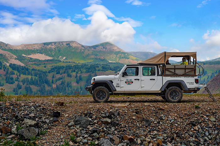 Wide view of a jeep on a mountain trail
