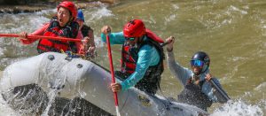 Close up of raft paddling through through the Lower Animas river in Smelter whitewater park in Durango, Colorado