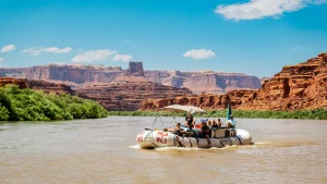 Boat motoring through the calm waters of the Colorado River outside of Cataract Canyon, Utah