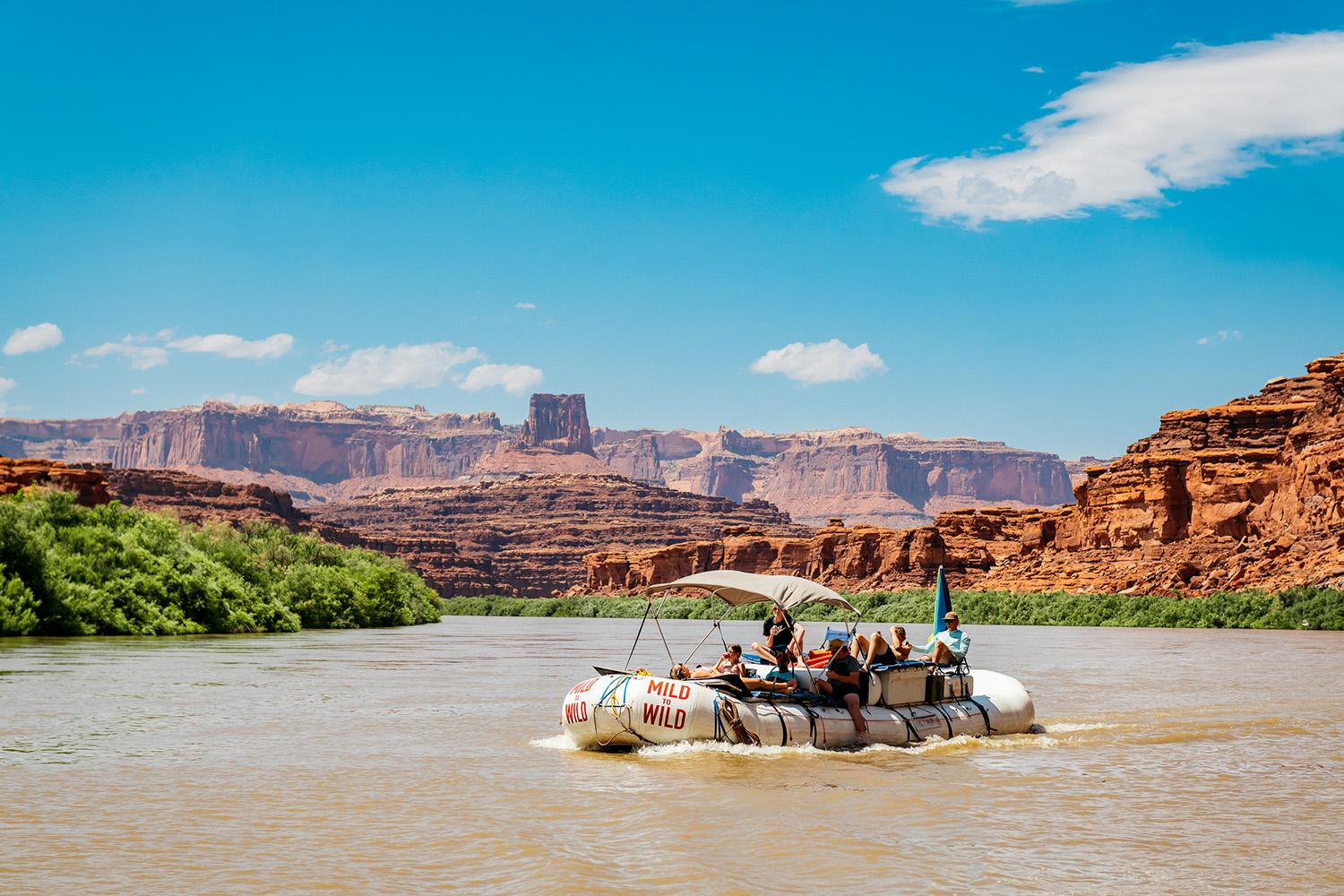 Wide shot of Cataract Canyon with a raft in the middle of the river - Mild to Wild