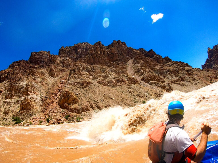 A guide watches Little Niagra rapid crash beside the boat in Cataract Canyon - Mild to Wild