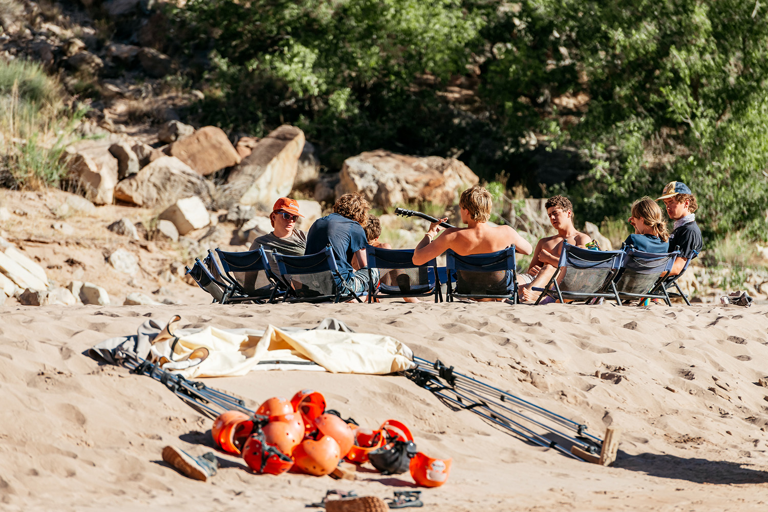 Group of people sitting in a circle on the beach - Cataract Canyon - Mild to WIld