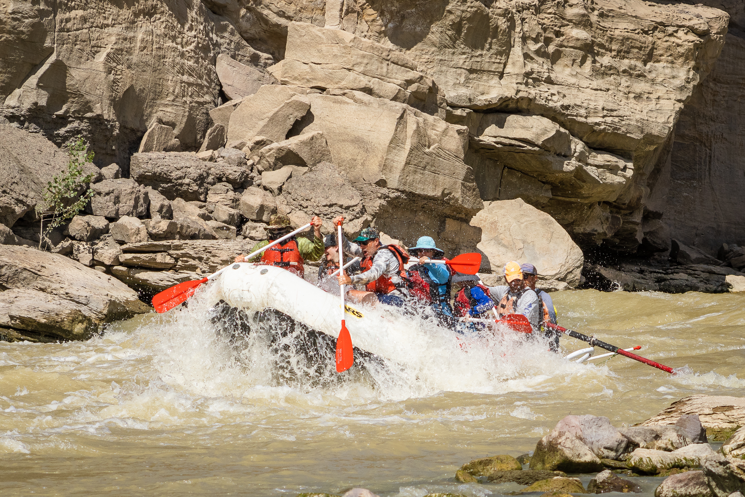 Big splash of rafts going through a rapid in Desolation Canyon