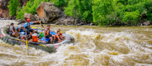 Rafting through whitewater - smiling people on - Mild to Wild