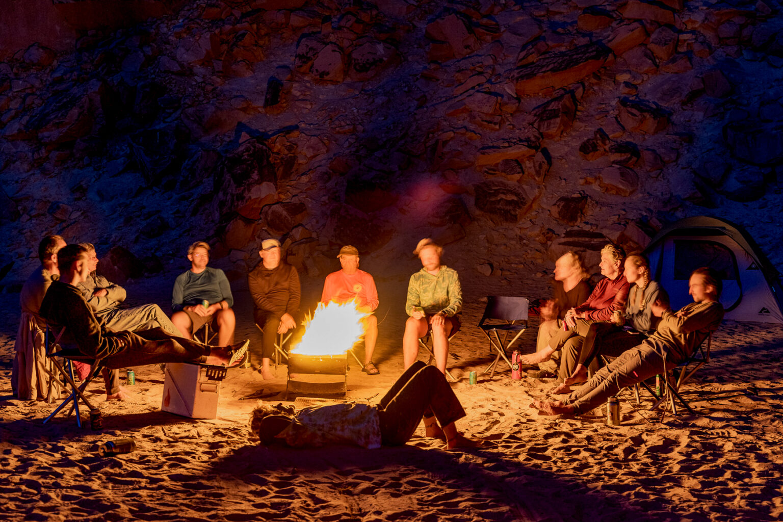 Group sits around a campfire on a Yampa River rafting trip - Mild to Wild