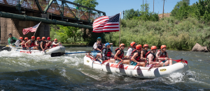 two white mild to wild rafts going down the Lower Animas River - American Flags