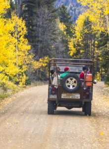 a jeep driving up a dirt road