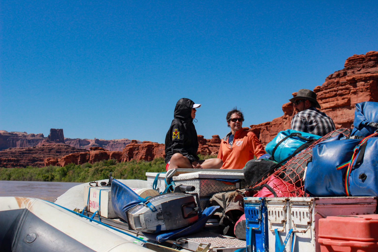 group on raft in Moab, Utah - blue sky