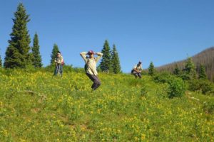 Volunteers in a field posing - San Juan Mountain Association - Mild to Wild