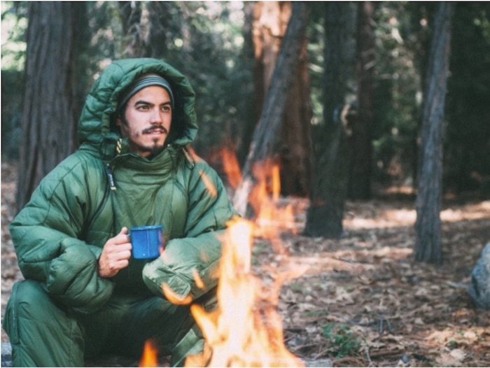 guy in wearable sleeping bag by campfire - Mild to Wild