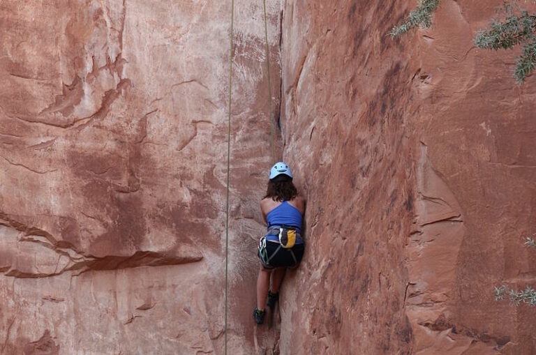 woman climbing crack on Potash Road, Moab - Mild to Wild