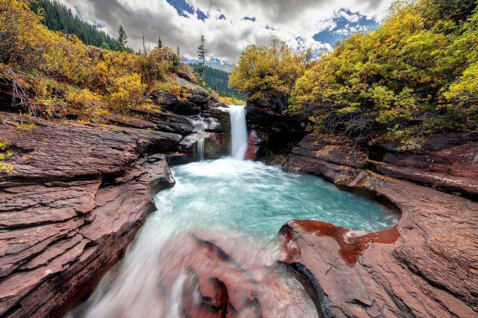 Small alpine waterfall surrounded by stone near Silverton, Colorado