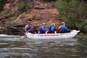 San Miguel River Rafting - medium shot of raft with rock wall