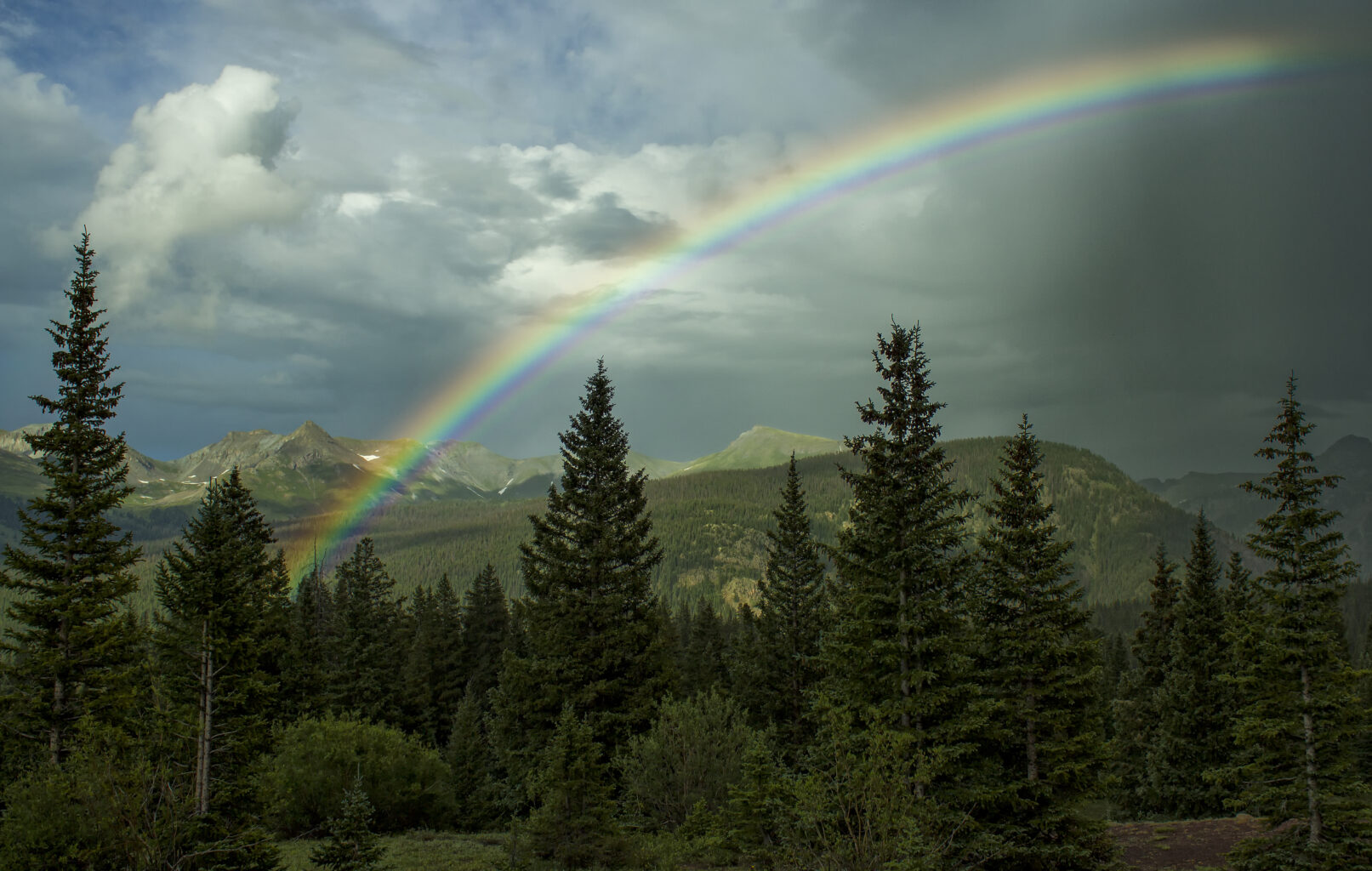 San Miguel - Rainbow in the sky with scenic view of La Plata mountains
