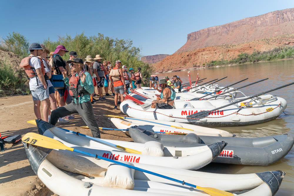 Castle Valley put in - Safety orientation - wide shot of guides talking to guests