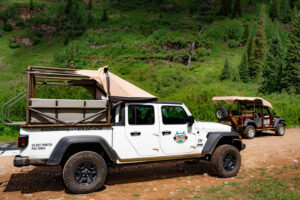 Close-up of Mild To Wild Jeep Gladiator with lush green La Plata mountains in the background - Durango Jeep Tours