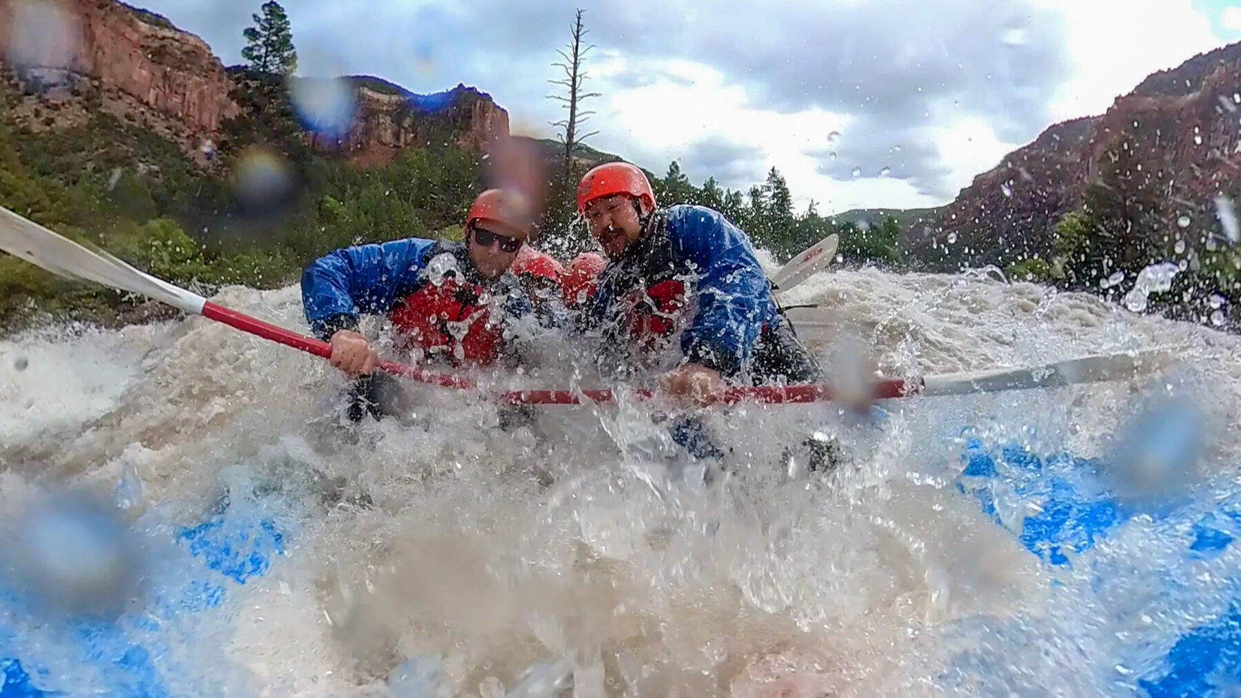 Guests on raft going through massive waves at Snaggletooth rapid on the dolores river - Mild To Wild