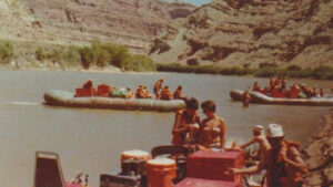 vintage style photo of people rafting on an Adventure Bound trip in the southwest - Shot of the river and guests on shore and in the water