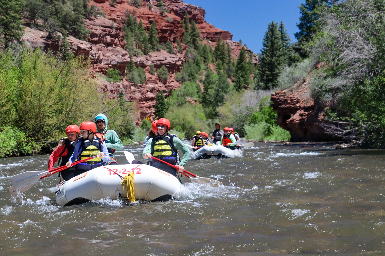 fleet of boats headed down the San Miguel River - Mild to Wild Rafting 