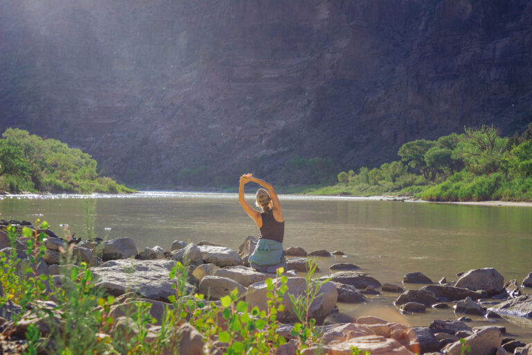 Woman stretching at camp in Desolation Canyon - Mild to Wild