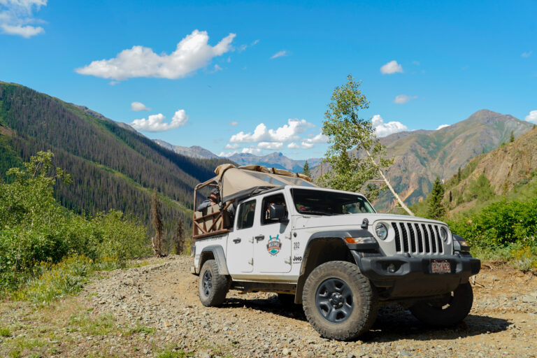 front view of Jeep Gladiator driving up a mountain with trees in background in Silverton CO - Mild to Wild