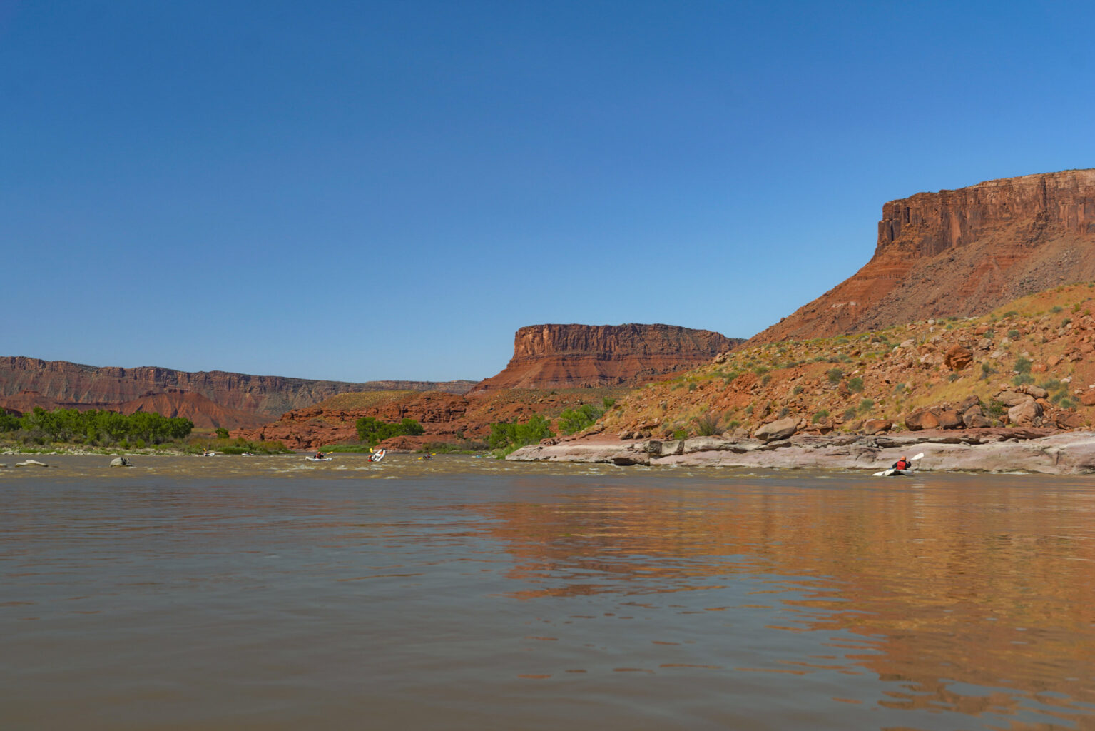 Wide shot of people inflatable kayaking in Castle Valley - Moab, Utah