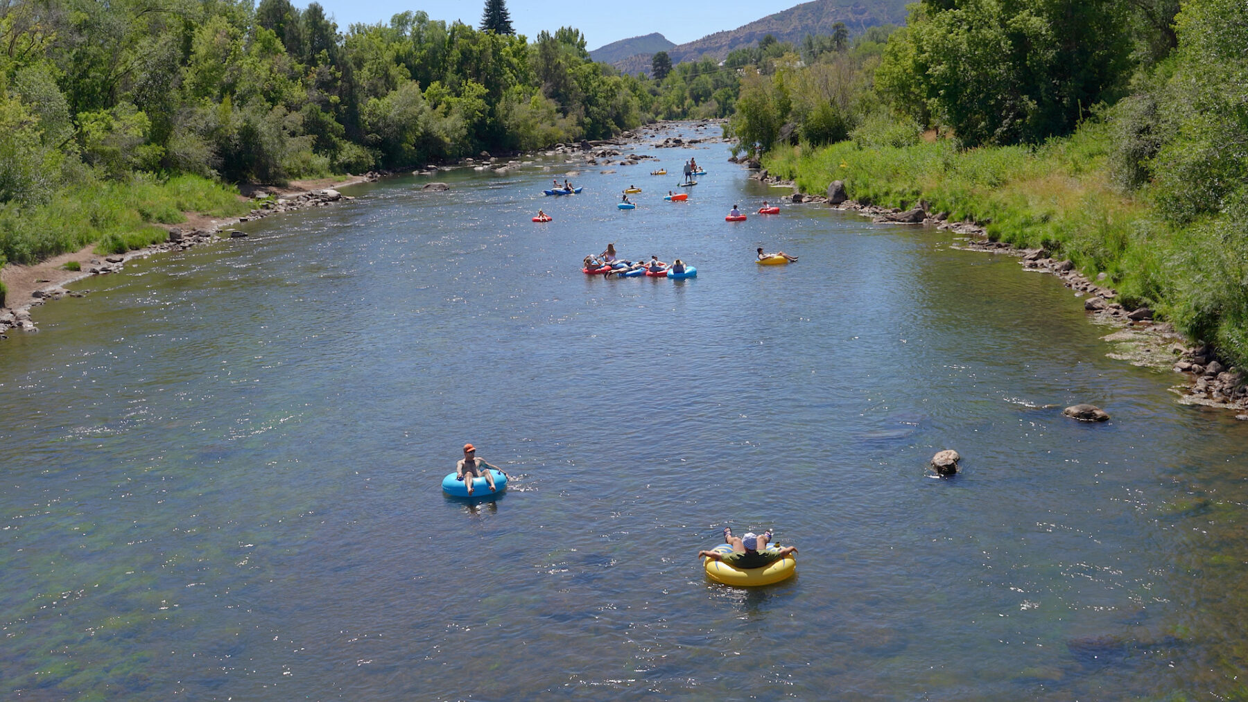 Wide shot of tubers going down the lower animas - mild to wild rentals