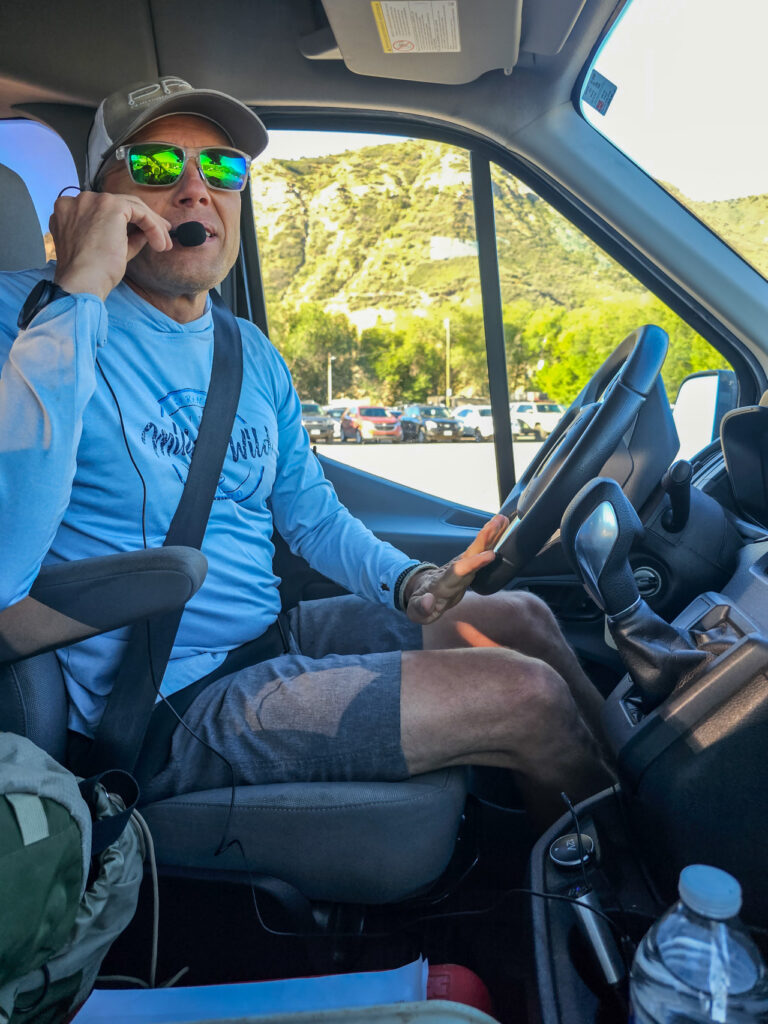 Close up of Van driver with headset microphone to his mouth wearing sunglasses - Mild to Wild