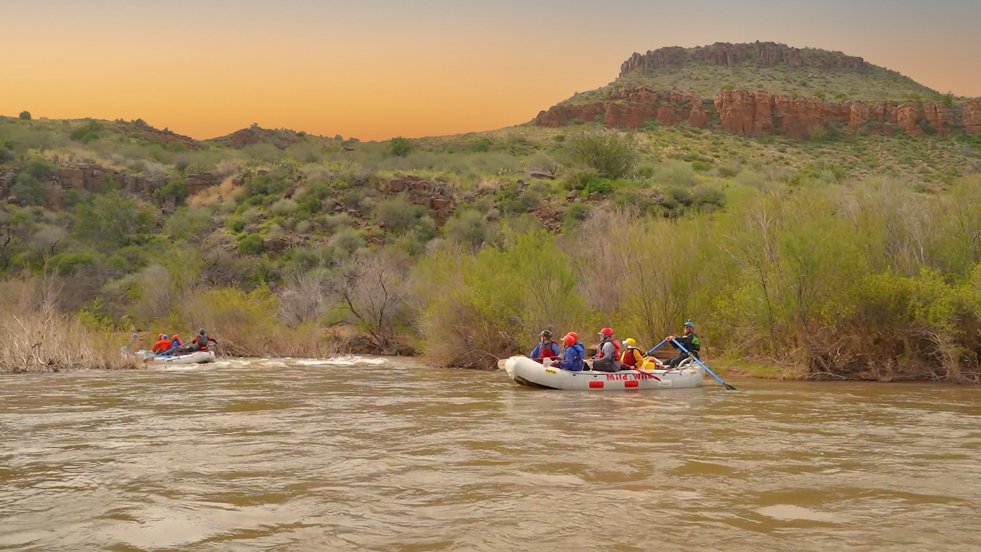 Salt river daily trip - wide shot of raft with guests and desert scenery