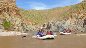 Wide shot of rafts on the salt river with desert scenery