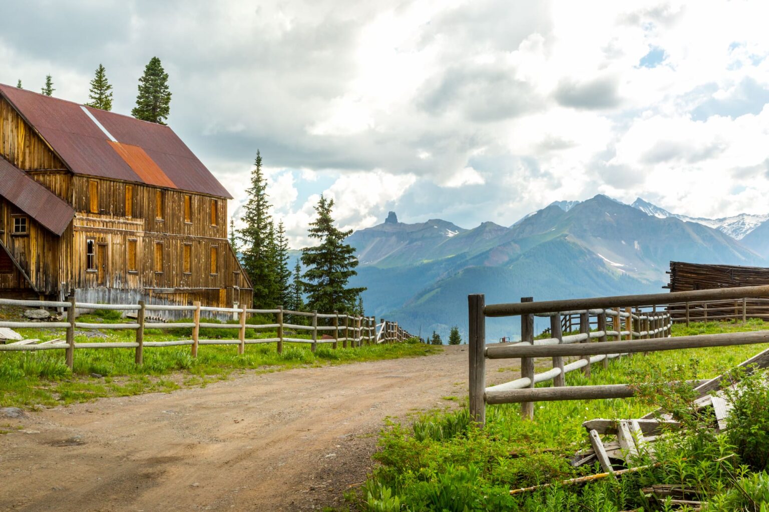 Medium shot of Alta Ghost Ton - cabin to right - mountain background