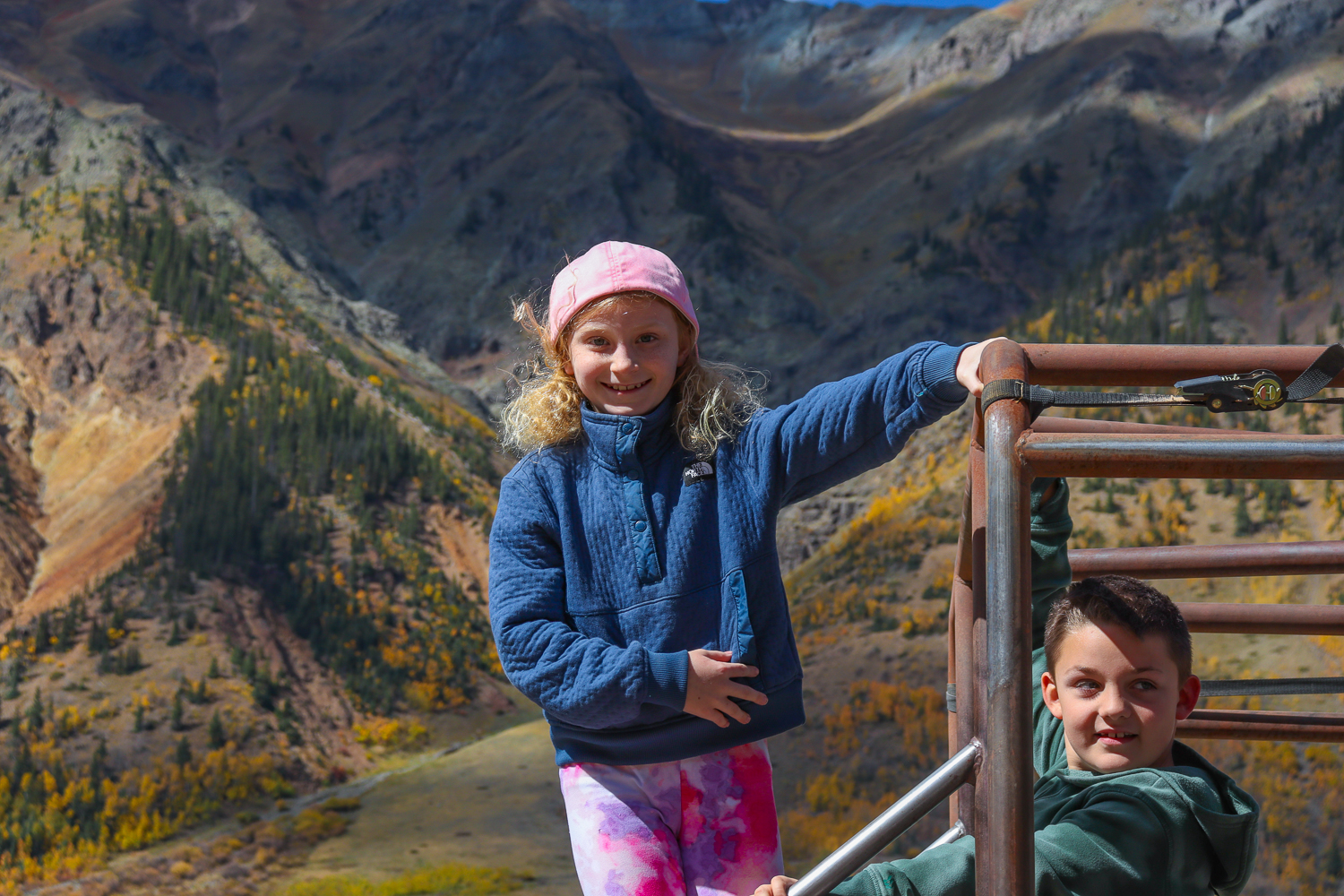 Young girl and boy smile while in the back of a Jeep on a Silverton Jeep Tour - Mild to Wild