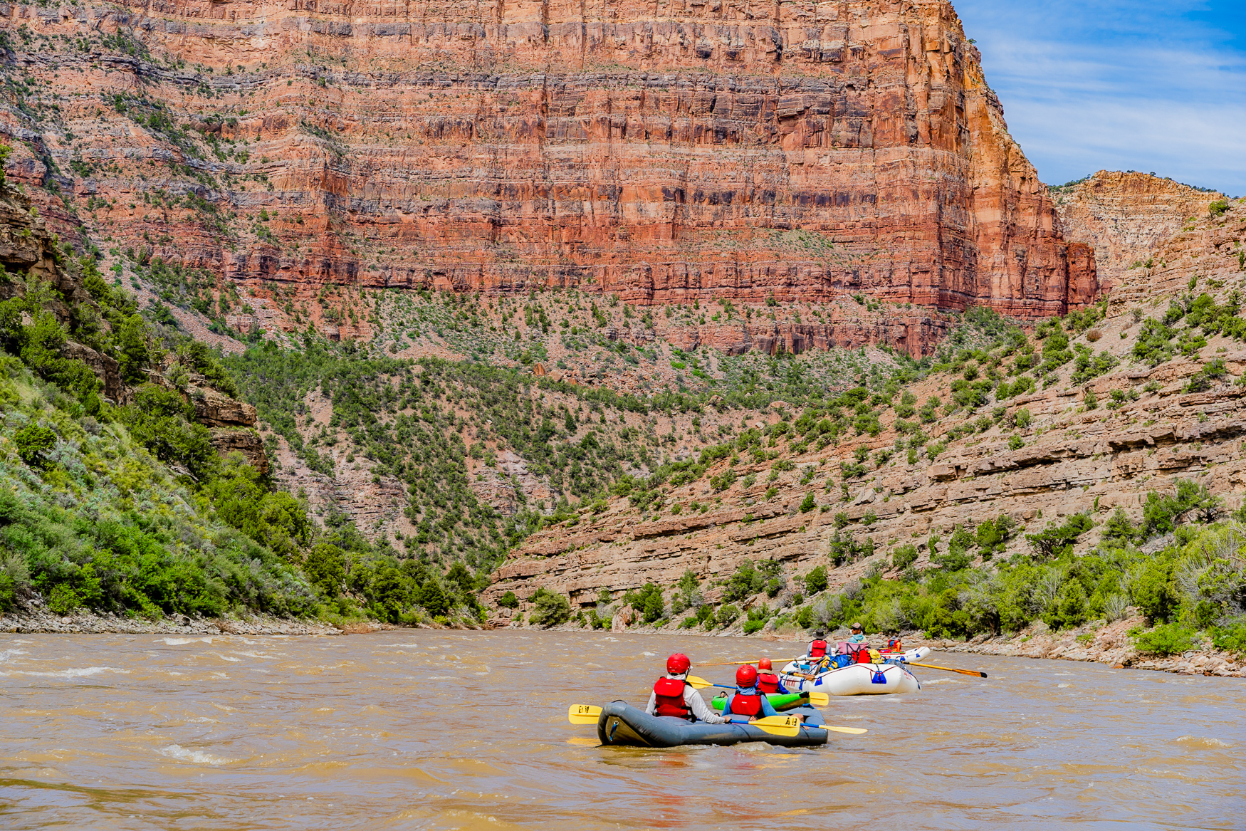 Kayakers and rafters floating beneath massive Humbug formation in the Yampa River Canyon - Mild to Wild