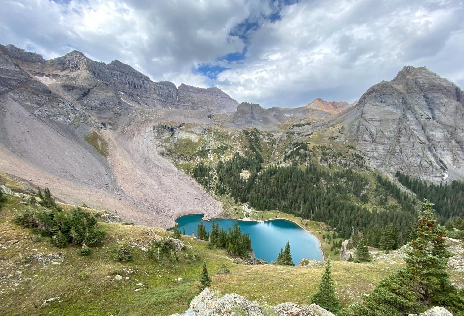 Bright blue lake nestled among mountains.