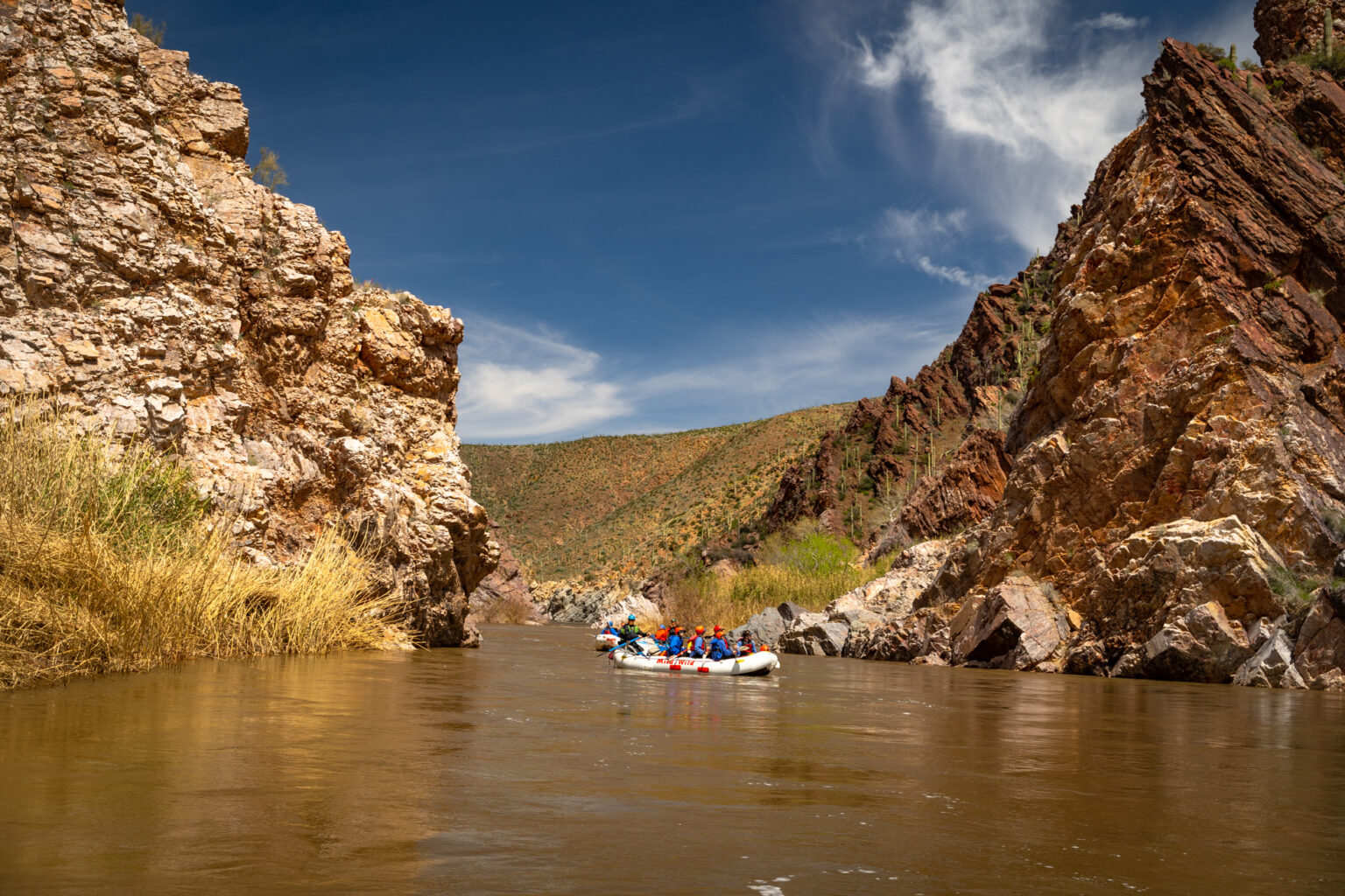 Boats in the Salt River surrounded by rock walls