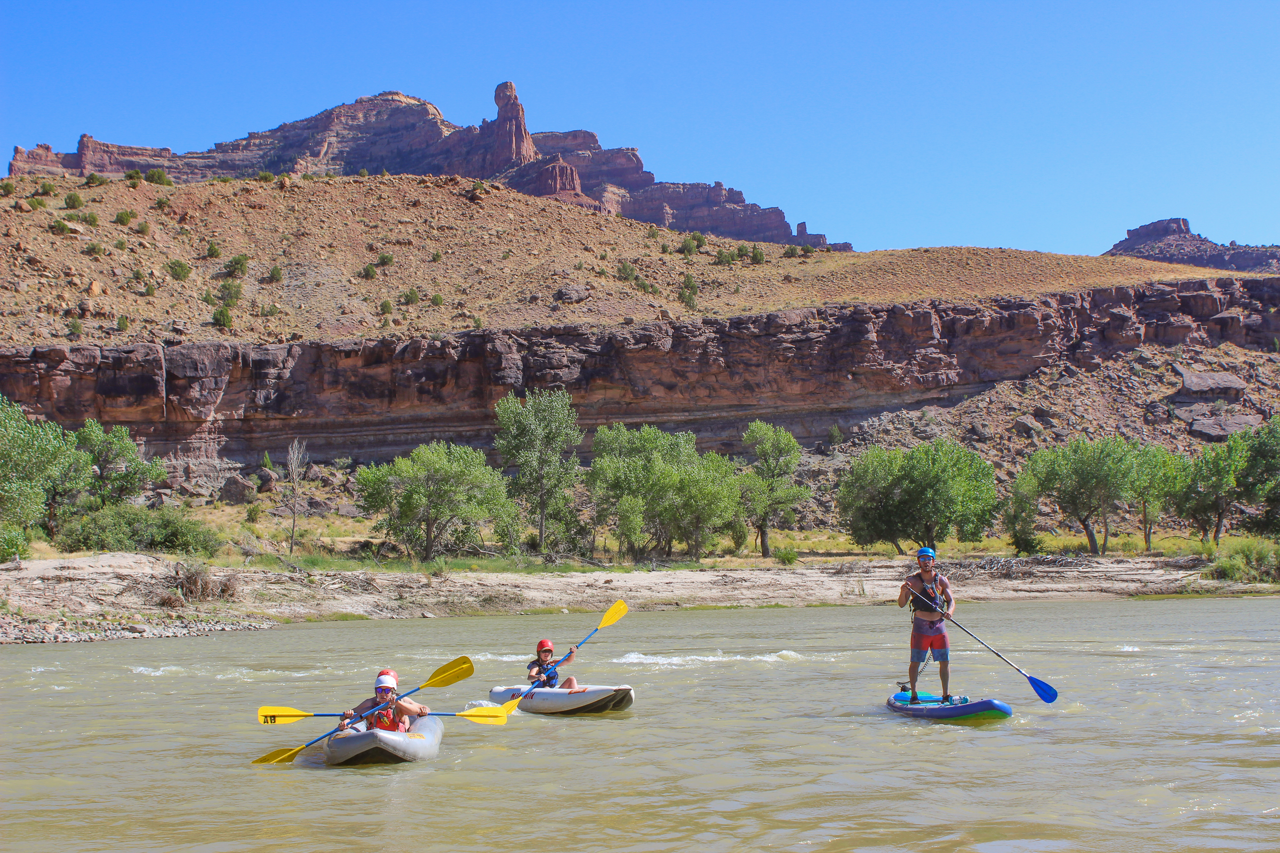 SUP and kayaks having fun on the Green River in Desolation Canyon