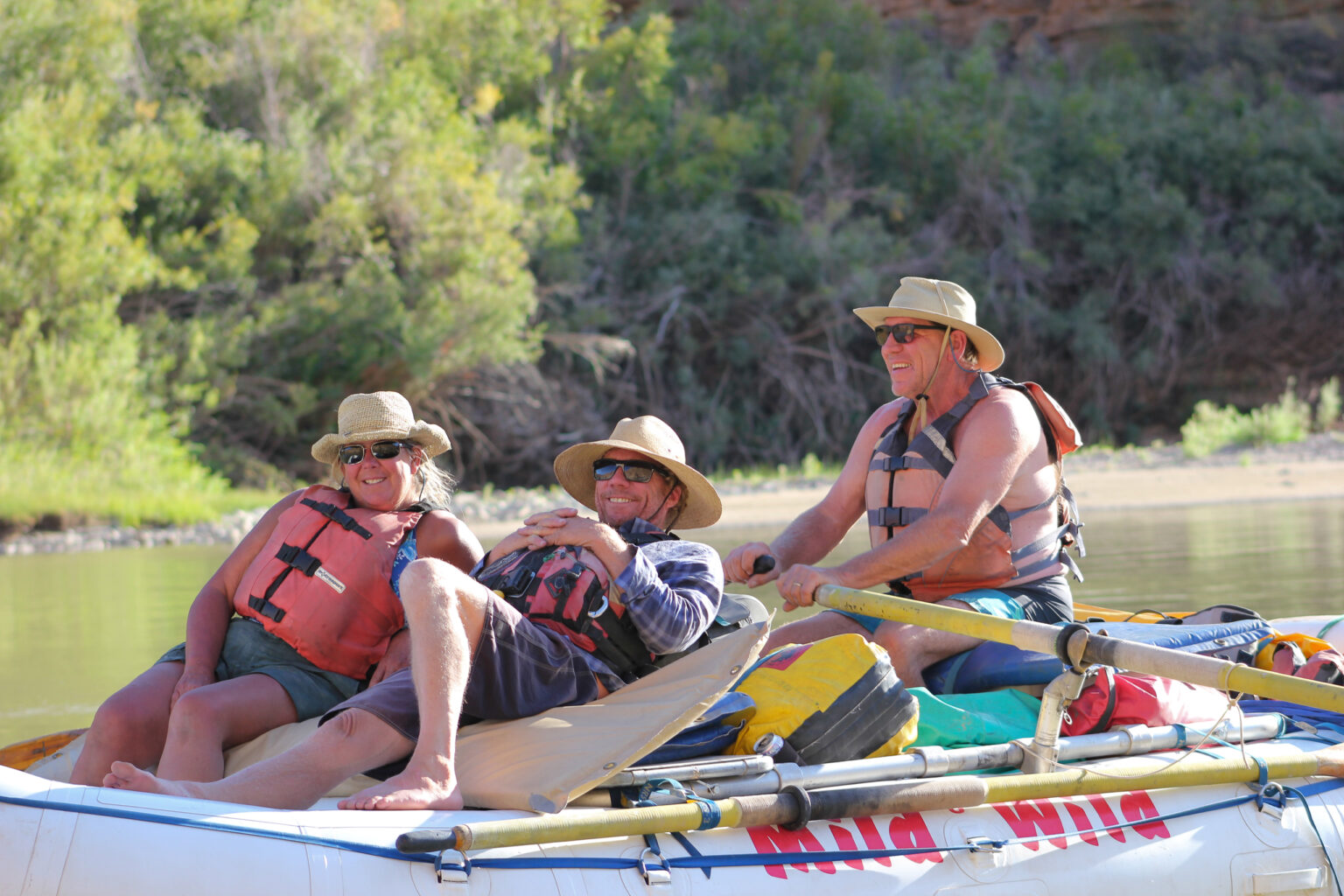 Group smiling on the raft in Desolation Canyon