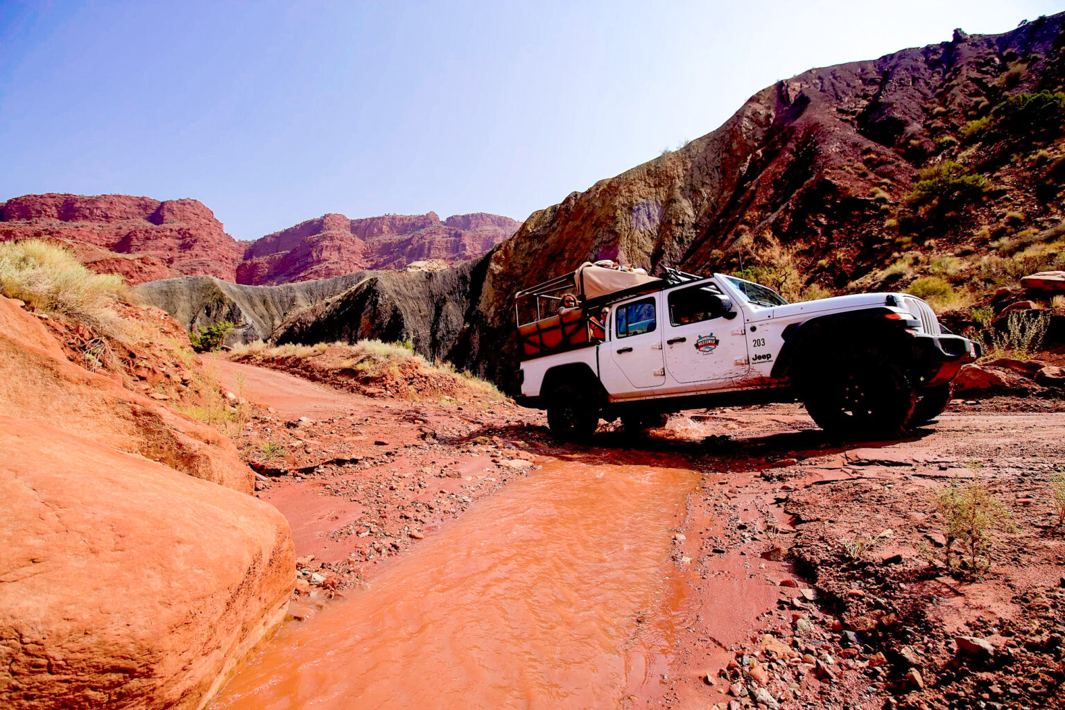 Jeep Gladiator crossing Onion Creek on a Moab Jeep Tour