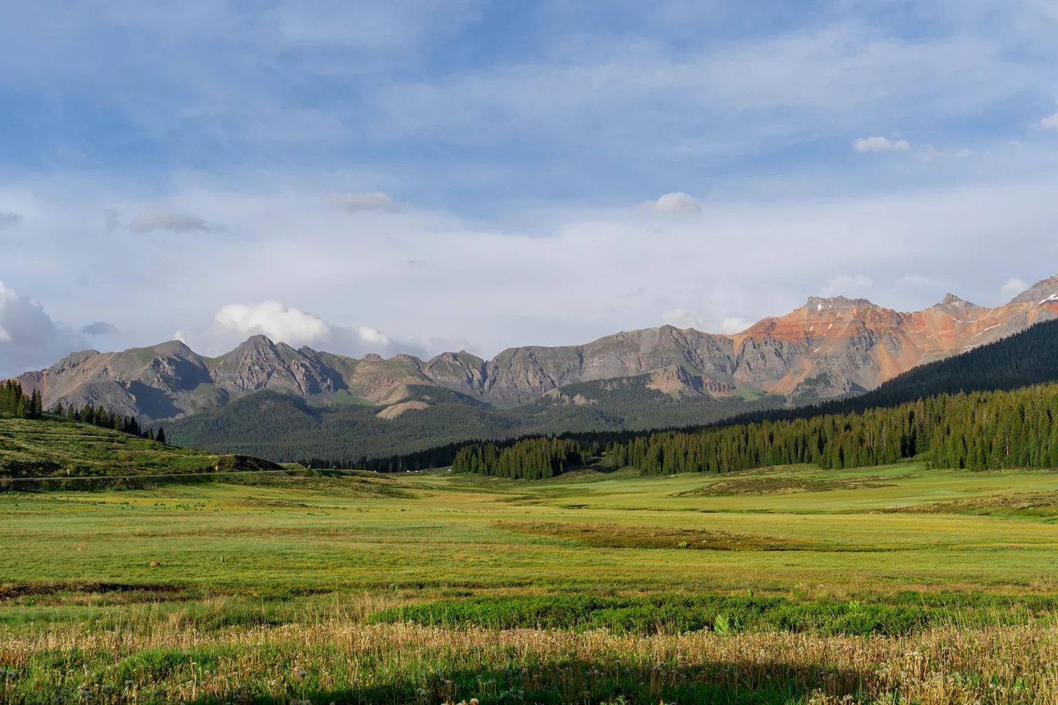 A green valley nestled in the San Juan mountains