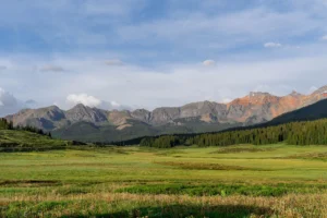 A green valley nestled in the San Juan mountains