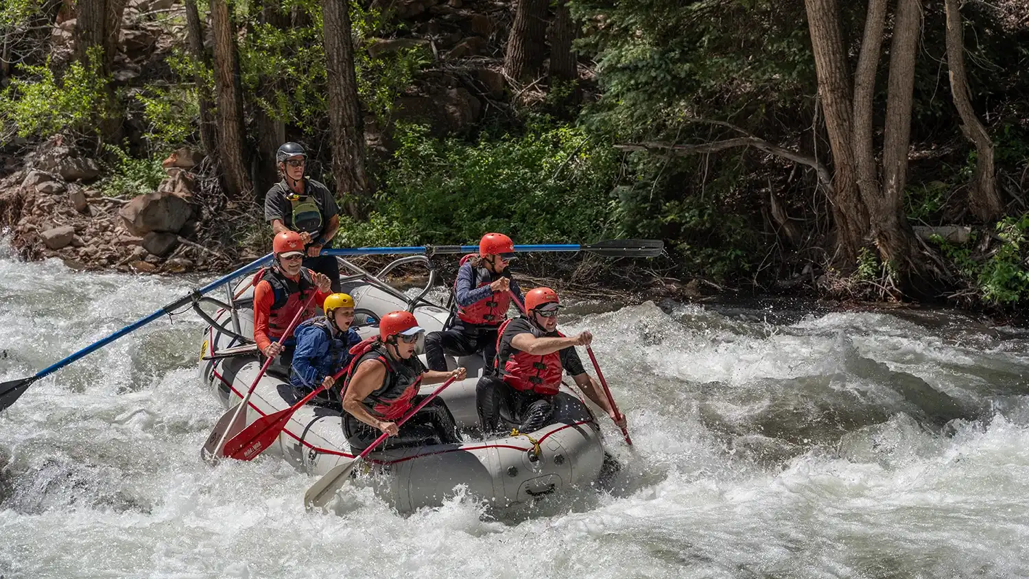 A rafting group navigating river rapids