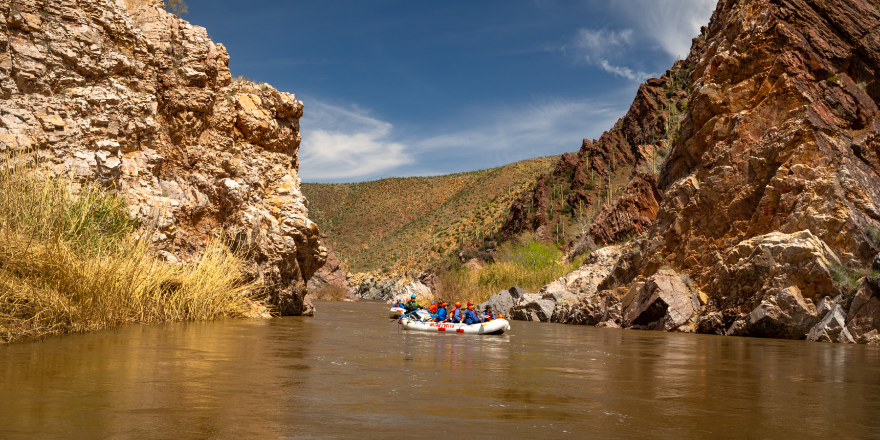 Scenic wide shot of raft in Salt Canyon on the Salt River - Blue Sky