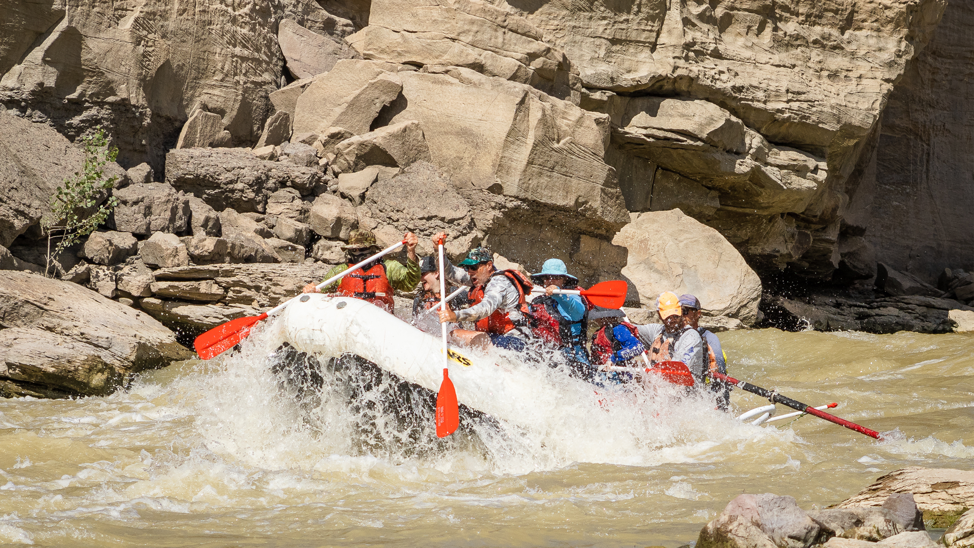 medium shot of raft paddling through whitewater in Desolation Canyon