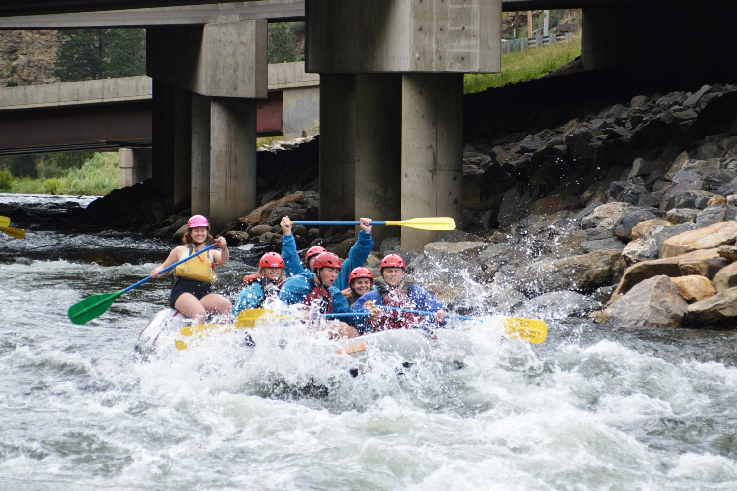 Rafting through whitewater in Clear Creek - Bridge behind with rocks on side - Idaho Springs, Colorado